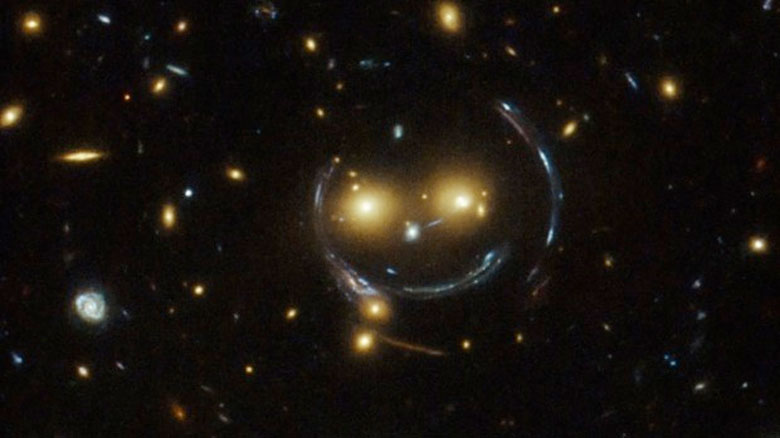  In the center of this image, taken with the Hubble Space Telescope, is the galaxy cluster SDSS J1038+4849 — and it seems to be smiling. Photo: NASA & ESA / Judy Schmidt 